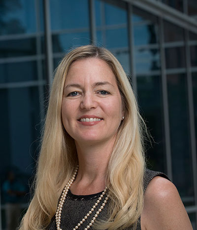 Liza Wilson Durant standing outside in front of a building facing the camera 