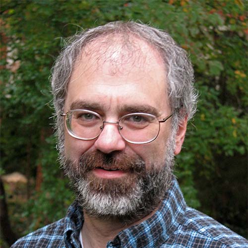 Mason professor Robert Simon a plaid-blue shirt and glasses