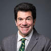Kenneth Strazzeri wears a gray suit and green tie in his headshot